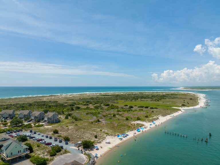 Aerial view of Serenity Point beach, sound-side water, dunes, and beachgoers