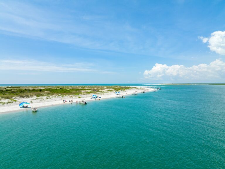 Aerial view of turquoise water and sandy shoreline at Serenity Point