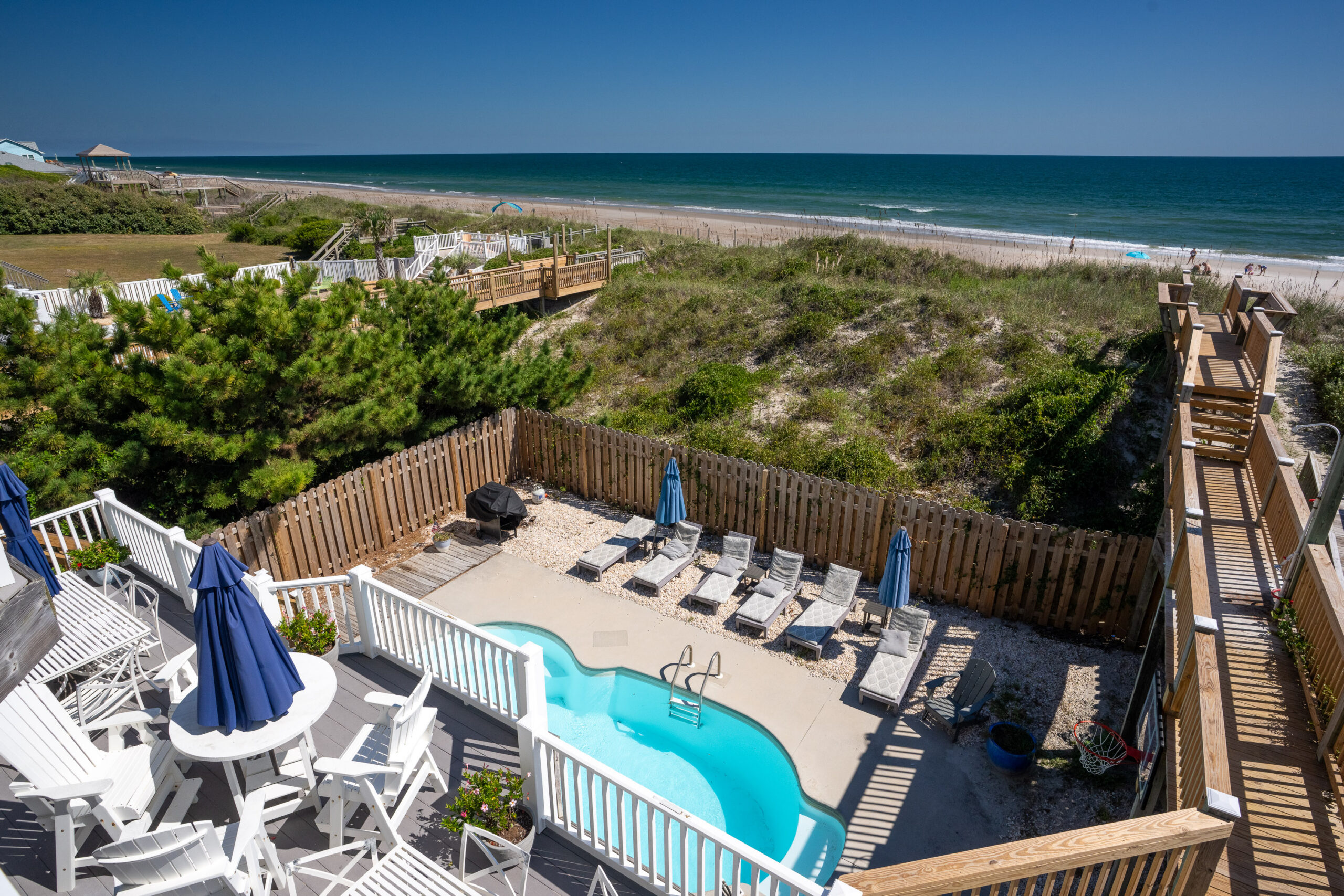 Pool, deck, dune walkway and ocean at Moondance on Topsail Island
