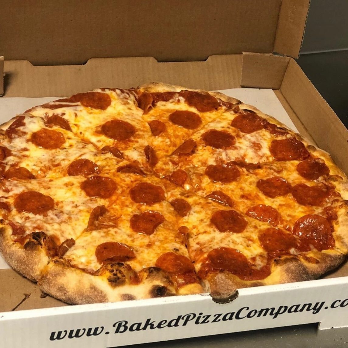 A pepperoni pizza in a Baked Pizza Company box