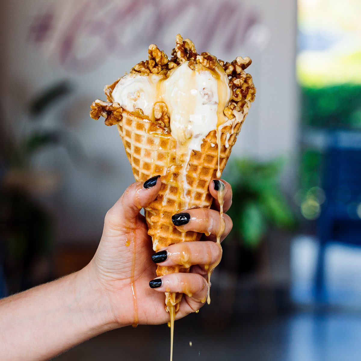 A waffle cone piled with Boombalatti’s maple walnut ice cream