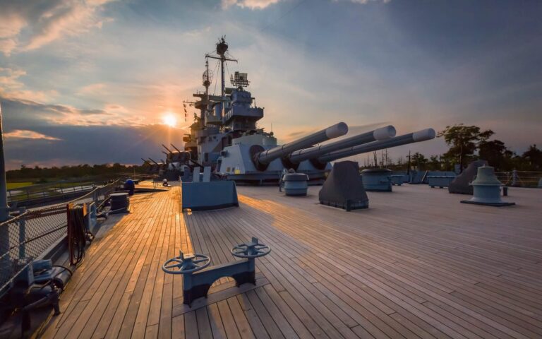 The main deck and guns of Battleship North Carolina at sunset