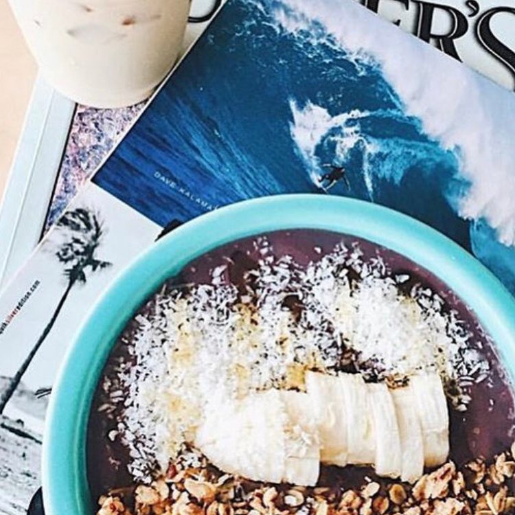 An açaí bowl topped with banana, coconut and granola