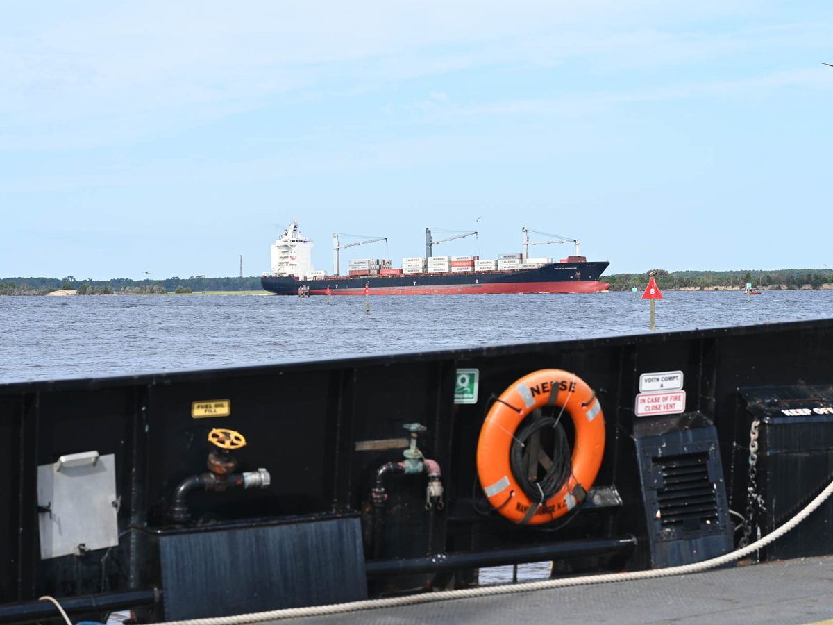 A cargo ship passing the ferry
