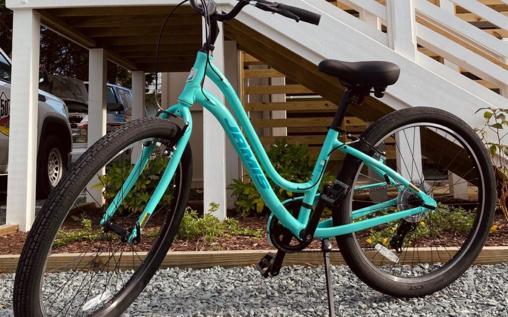 A teal rental beach cruiser outside 50 South Surf Shop