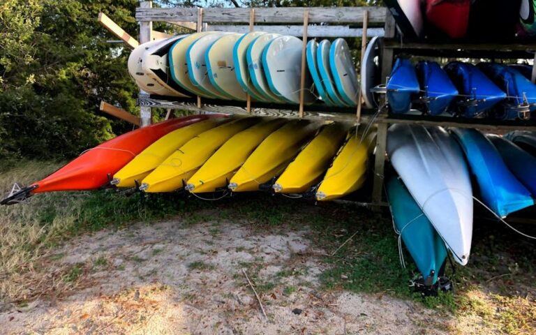 Colorful kayaks and paddleboards on a rack
