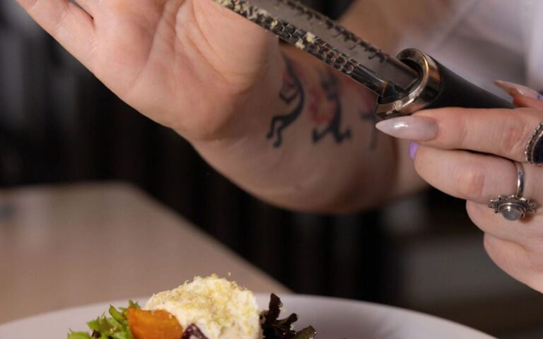 A chef finishing a plated salad