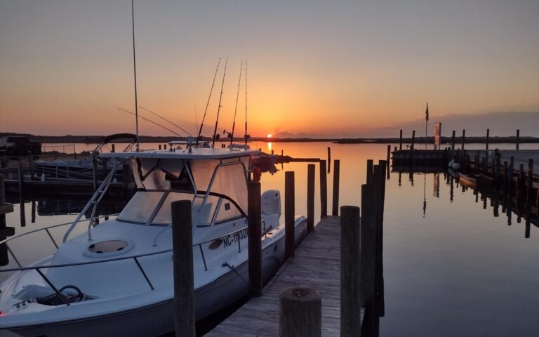 A fishing boat at the marina dock at sunset
