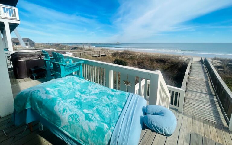 A massage table set up on an oceanfront deck