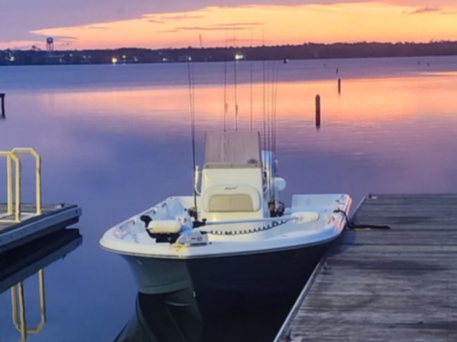 A charter boat at the dock at sunset