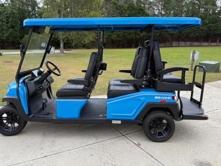 A blue six-seat golf cart
