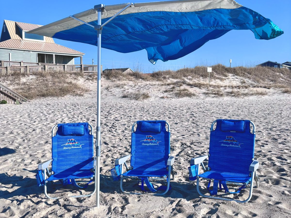 A Solbello shade over three beach chairs