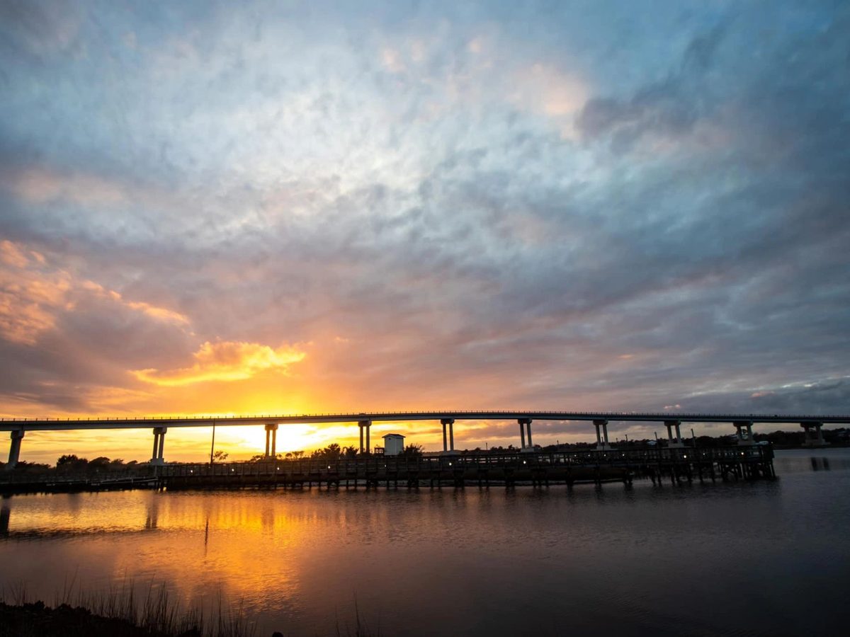 Sunset over the sound with the bridge on the horizon