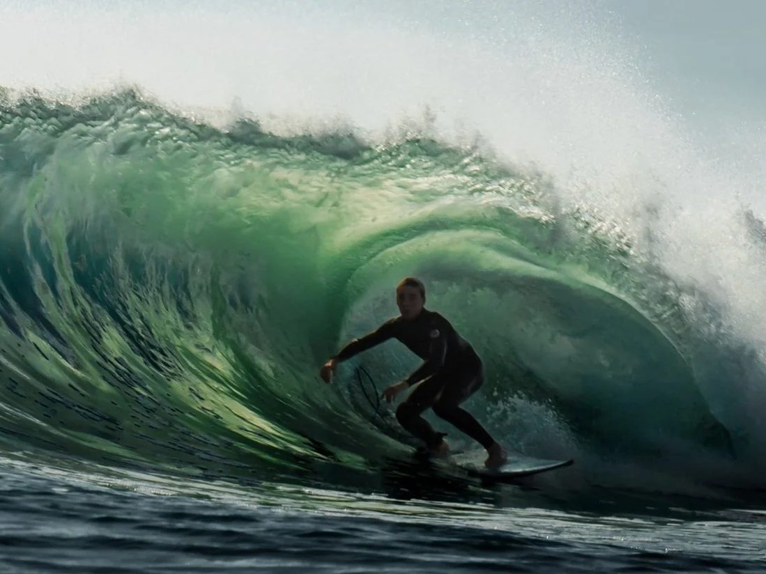 An instructor surfing inside a wave