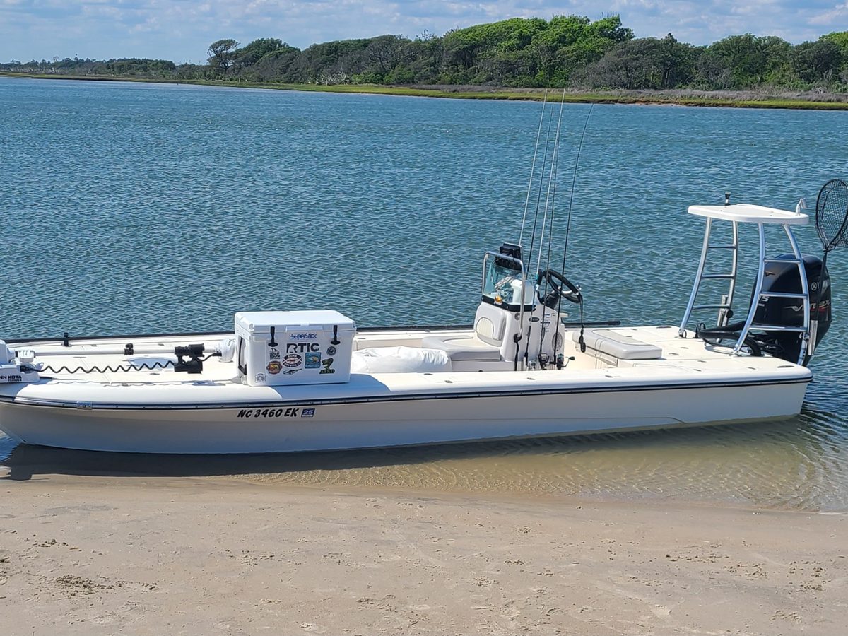 An inshore skiff beached on a sandy shore