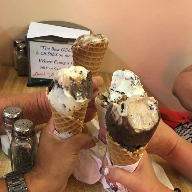 Hand-dipped ice cream cones held over a table at Island Delights