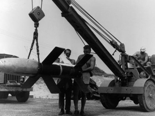 Historic photo of a missile being moved by crane during Operation Bumblebee