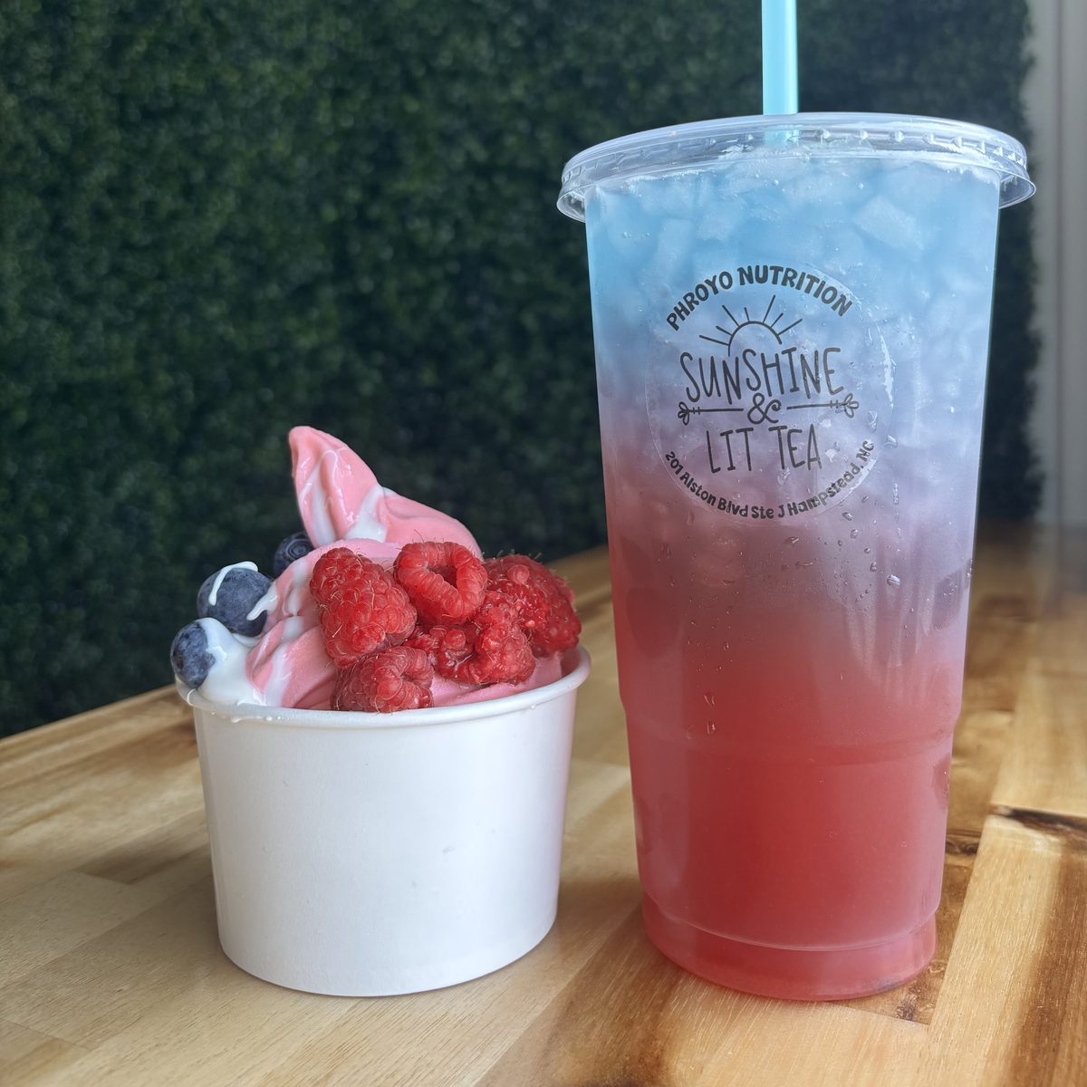 Frozen yogurt with raspberries beside a layered iced mega tea