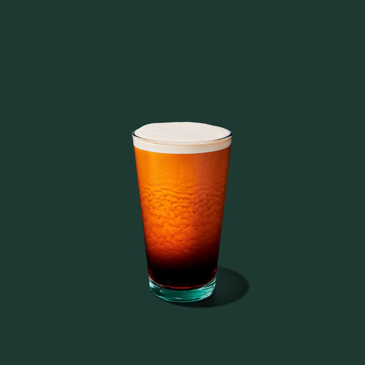 A glass of nitro cold brew with a creamy head