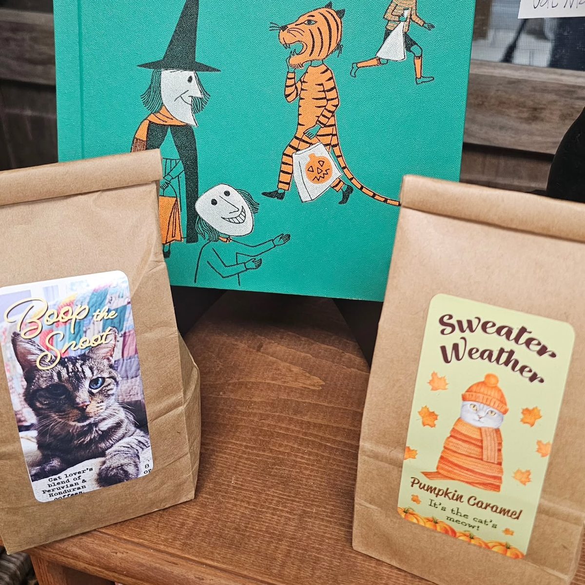 Bags of Small Craft coffee, Boop the Snoot and Sweater Weather, on a shelf at Sugar Island