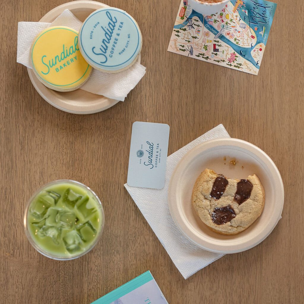 A latte, an iced matcha and cookies on a table at Sundial Coffee & Tea
