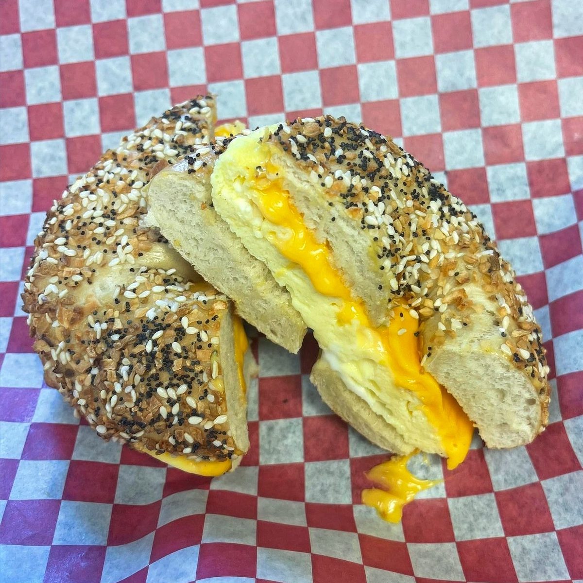 An egg and cheese sandwich on an everything bagel