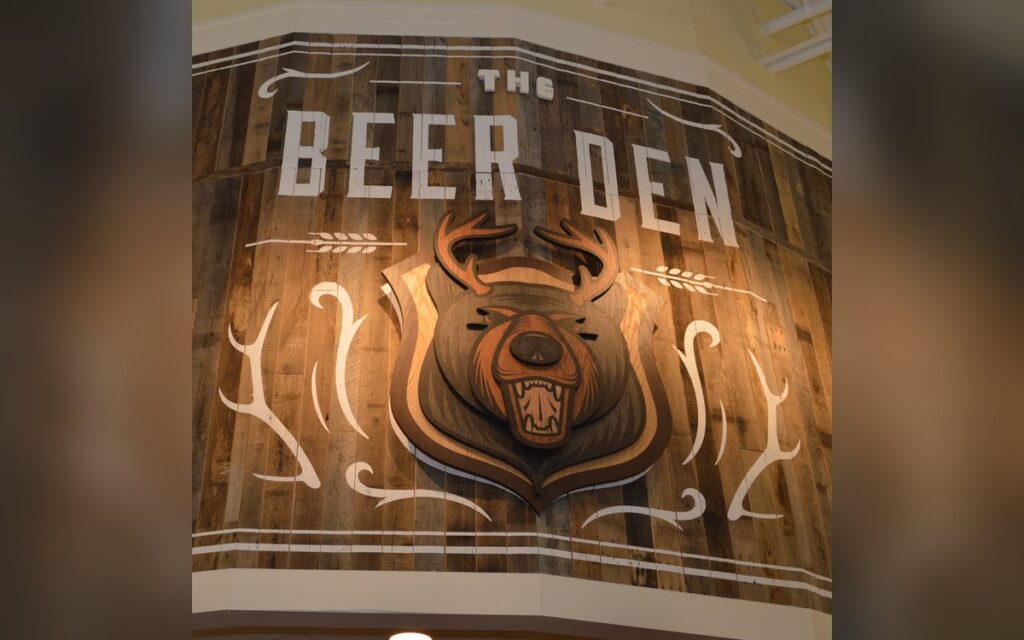 The Beer Den sign at a Lowes Foods store