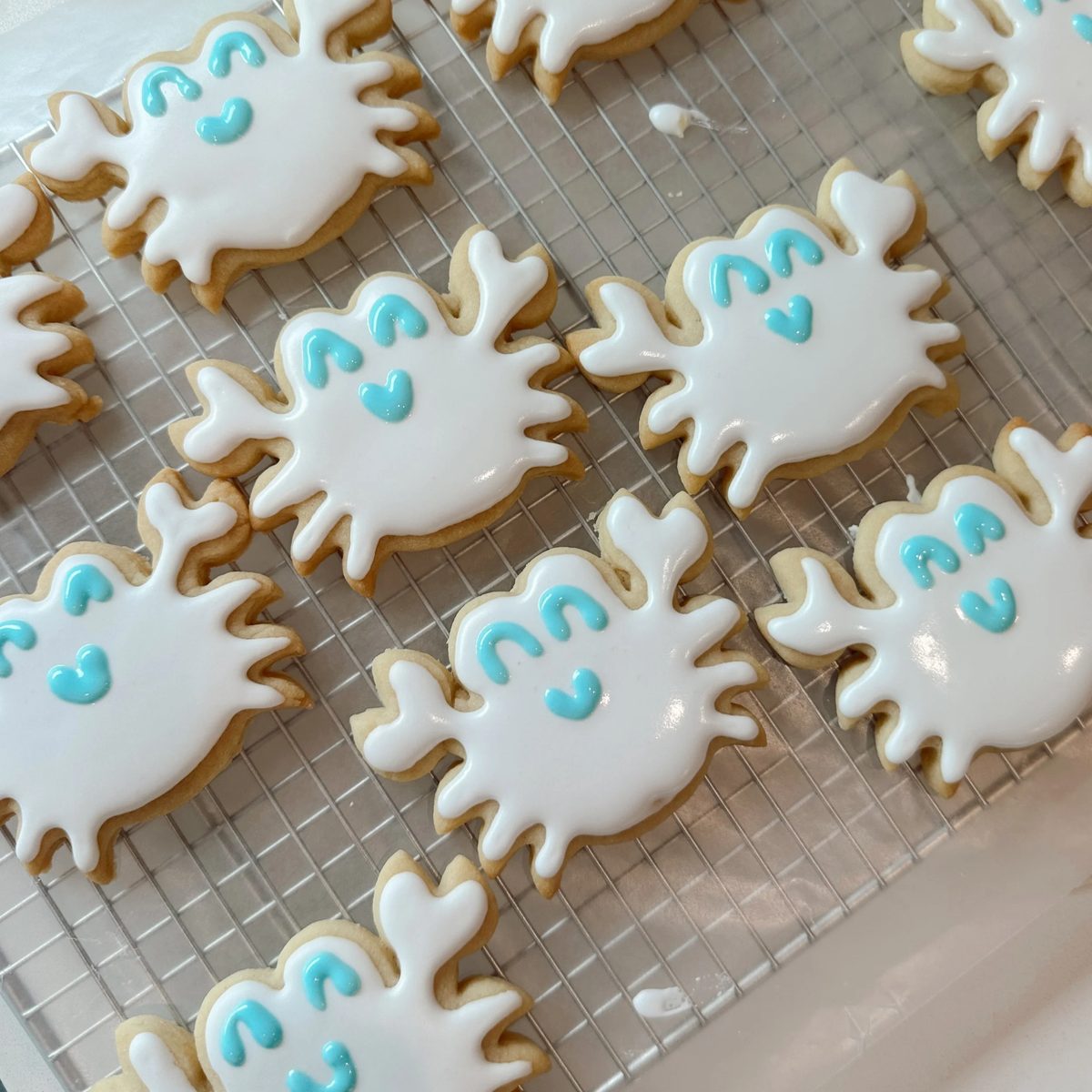 Crab-shaped iced sugar cookies on a cooling rack